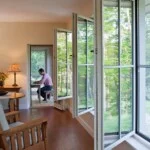 GO Home by GO Logic 1,000 ft² plan A dining and living room area showing over-sized windows.